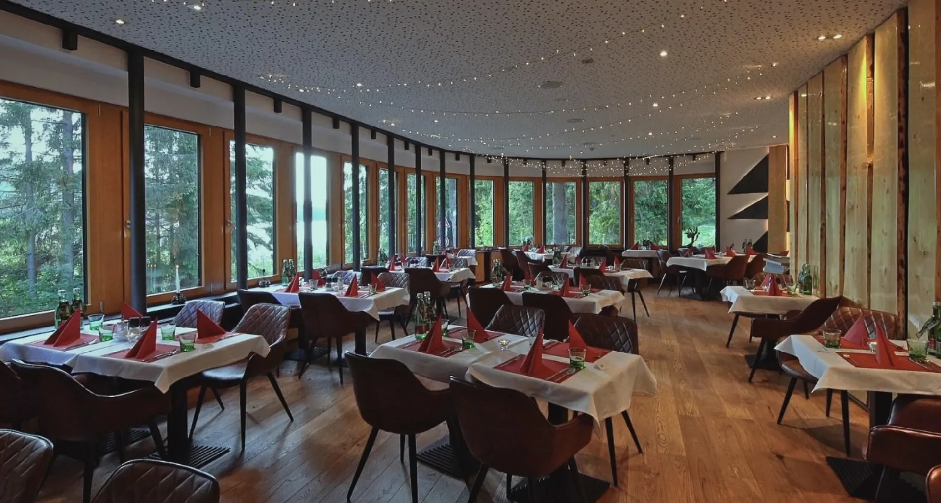Interiér restaurace hotelu Montanie s výhledem do přírody Jizerských hor